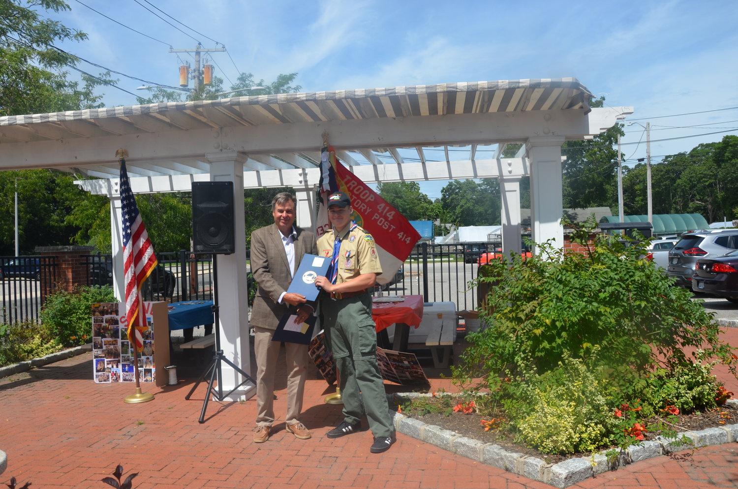 Eagle Scout Steven Rosche is presented with a citation from Suffolk County Legis. Al Krupski.